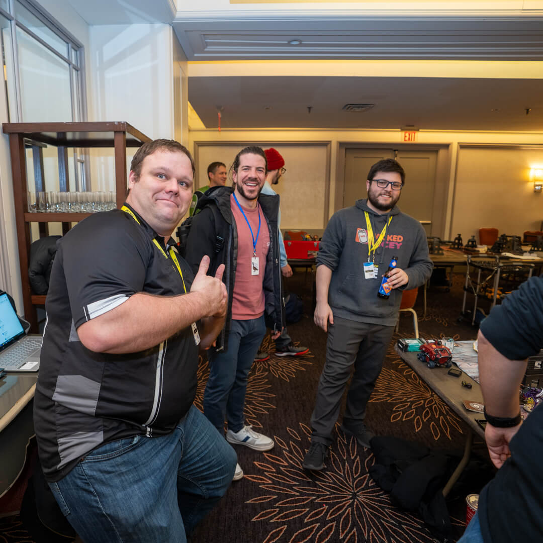 Dsc06855 Wicked Dicey Three Men with Lanyards Posing and Smiling in a Hotel Conference Room Setting