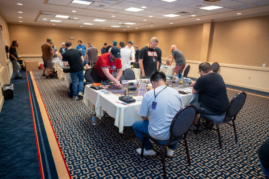 Dsc08655 Wicked Dicey People Gathered Around a Tabletop Gaming Table in a Hotel Conference Room During a Convention