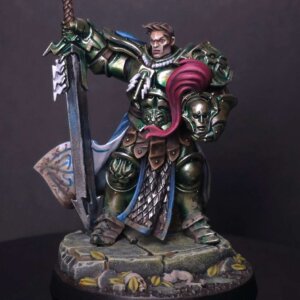 Fantasy knight in green armor with a blue cape, wielding a large sword and holding a severed head on a rocky base.