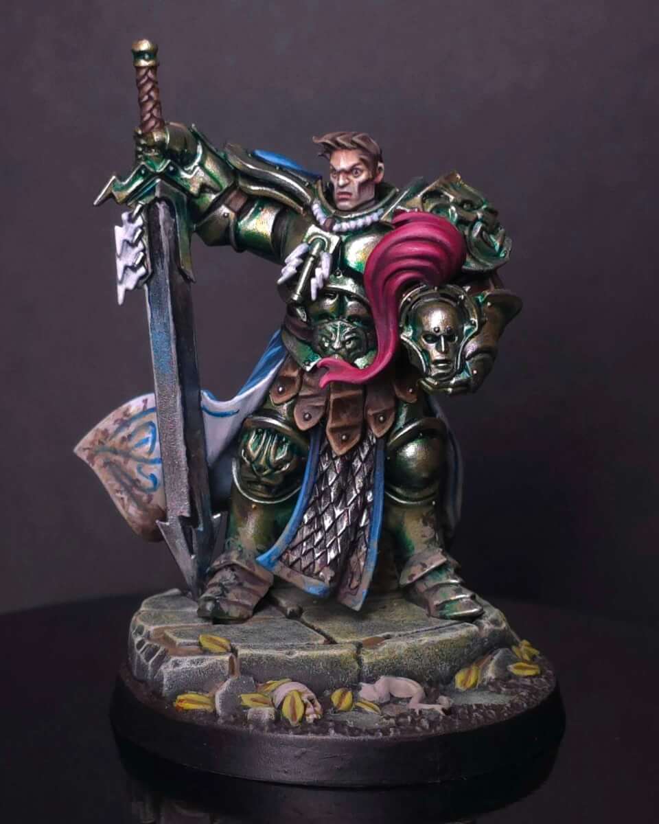 Martin Tmm Gold Wicked Dicey Fantasy Knight in Green Armor with a Blue Cape Wielding a Large Sword and Holding a Severed Head on a Rocky Base