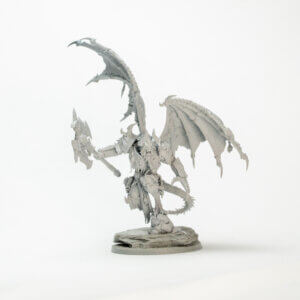 Unpainted gray dragon miniature with large wings, armored body, and a spiked weapon on a rocky base.