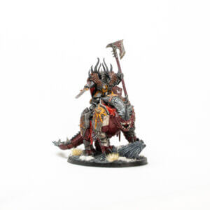 Armored demon riding a spiked dragon miniature, wielding a large axe and sword, on a rocky snowy base.