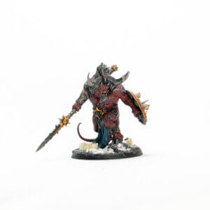 Red-skinned demon miniature wielding a spiked spear and a round shield on a snowy base, wearing jagged armor and horns.
