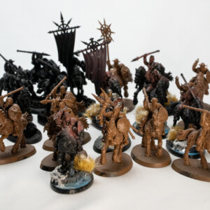 Group of brown and black fantasy miniatures mounted on horseback, armed with spears and shields, arranged for wargaming.
