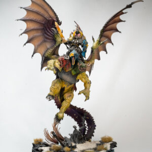 Colorful dragon creature with a armored rider, wings spread, perched on a snowy base.